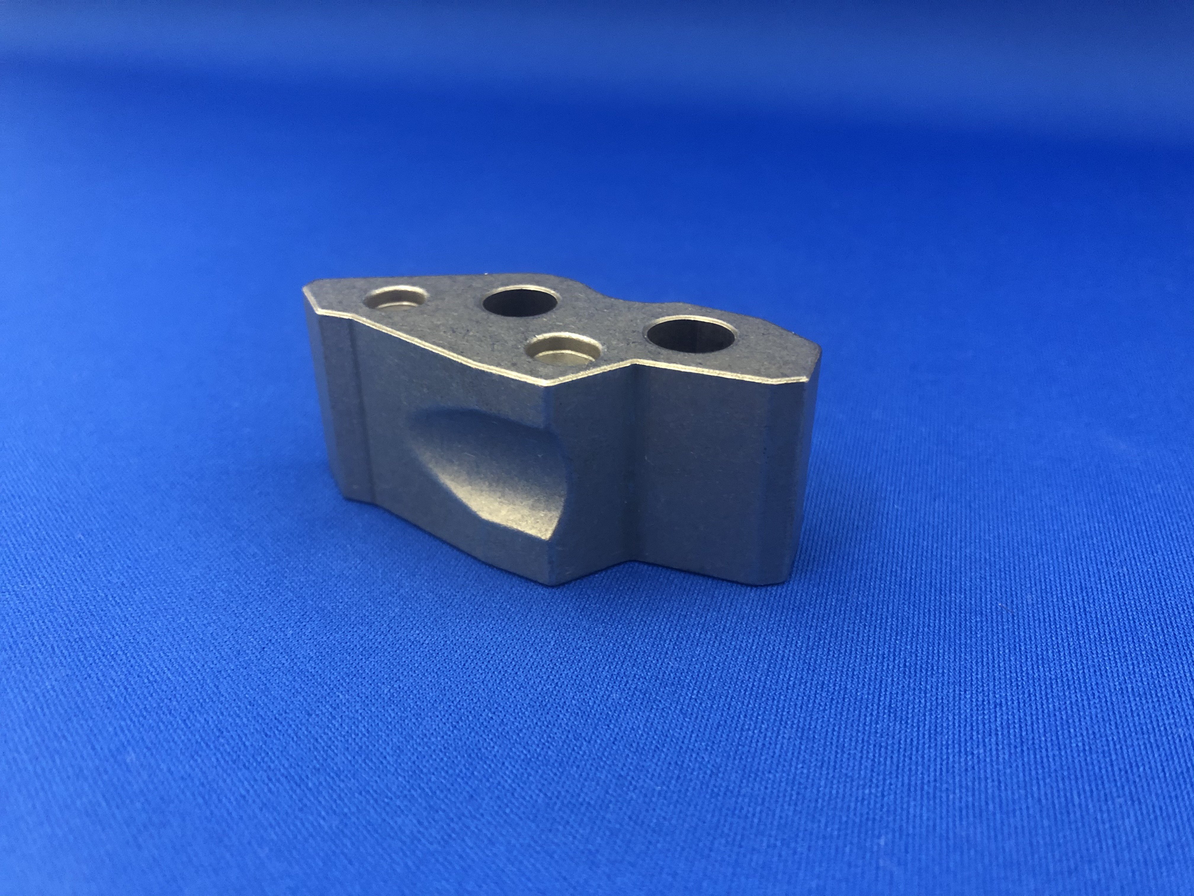 Cost reduction by making curvature grooves for parking lock parts using conventional press mechanism